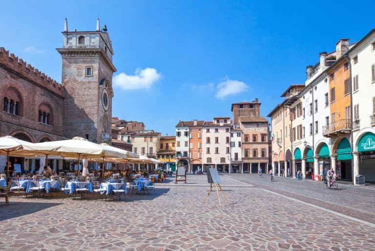 Scorcio panoramico di Piazza delle Erbe a Mantova con la Torre dell'Orologio e i palazzi medievali dei Gonzaga